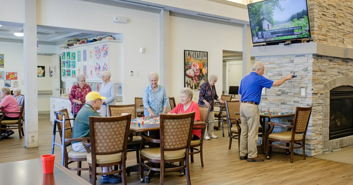 Gardens at Columbine residents gathered for tabletop games in a bright activity room.